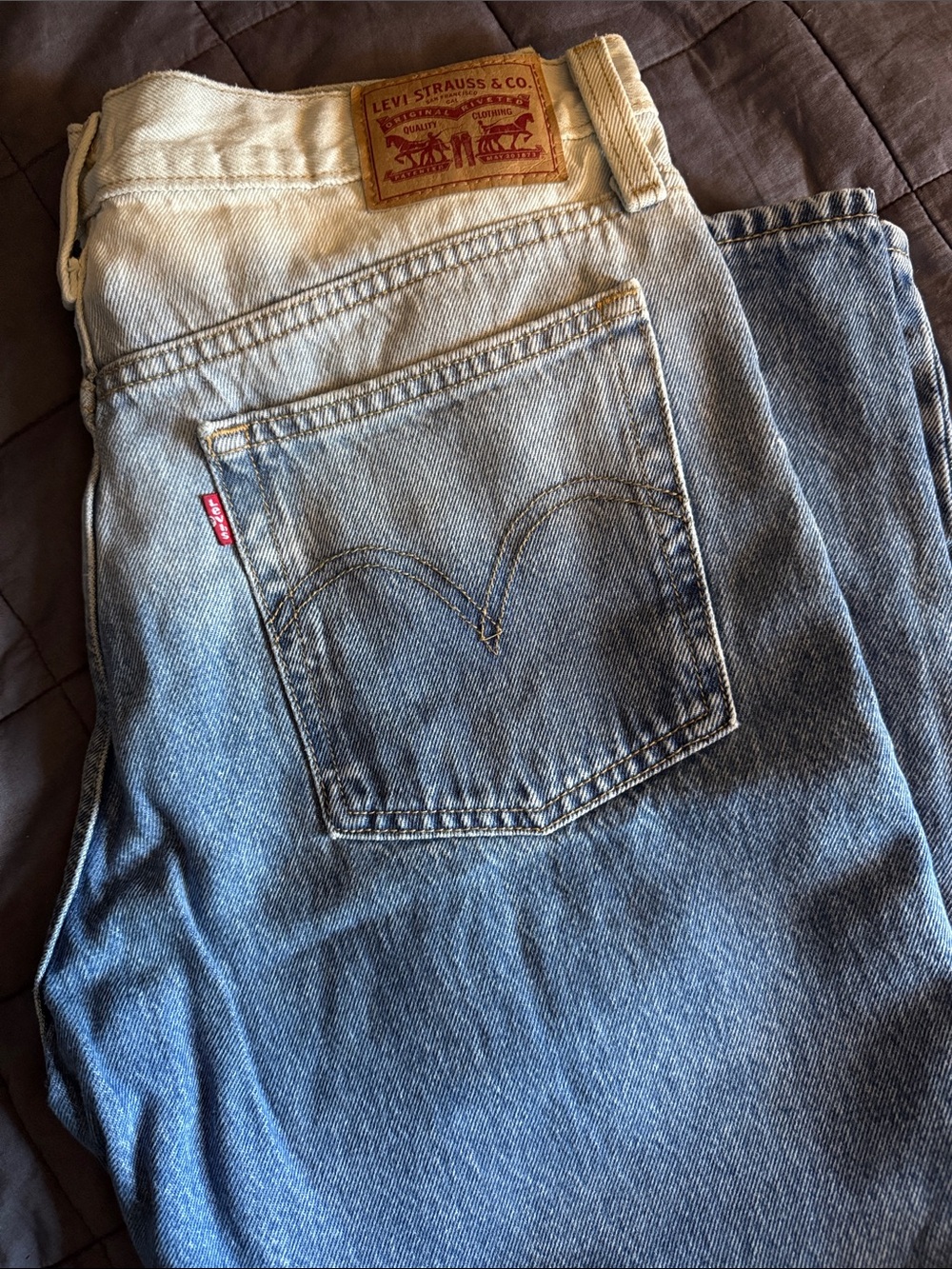 Levi's faded light blue denim jeans with cream waistband